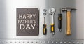 Happy Father s Day card with a spanner isolated on a metal background Royalty Free Stock Photo