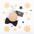 Happy Father`s Day Background. Cup of coffee and black bow tie on white background flat lay. Floral Fathers day. Royalty Free Stock Photo