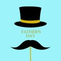 Happy father`s day background. Hat top hat and mustache on a stick, blue background. Congratulatory background.