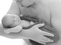 Happy father`s day! Black and white portrait a newborn baby in dadÃ¢â¬â¢s arms is sleeping Royalty Free Stock Photo