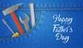 Happy Father`s Day card with tools in the denim pocket, wrench and screwdriver