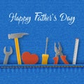 Happy Father`s Day card with tools in the denim pocket, wrench and screwdriver