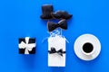 Happy Father`s day cards. Black tie, mustache and hat cookies and gift. Blue background top view Royalty Free Stock Photo