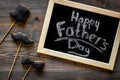 Happy Father`s day cards. Black tie, mustache and hat cookies. White desk background top view Royalty Free Stock Photo