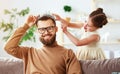 Happy father`s day! child daughter in crown does makeup to daddy Royalty Free Stock Photo