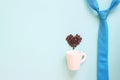 Happy Father`s Day concept with blue colour necktie and coffee cup with coffee beans heart shape on pastel Royalty Free Stock Photo