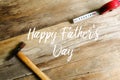 Happy father& x27;s day concept. Hammer and measuring tape on wooden background