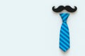 Happy FatherÃ¢â¬â¢s Day concept with mustache and neck tie on white background, Top view with copy space.