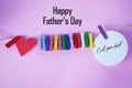 Happy Father`s Day concept with red heart shaped attached on rope, colorful paper clips and text message - call your dad. Royalty Free Stock Photo