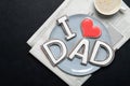 Happy Father`s Day concept. Tasty cookies and cup of coffee on wooden background