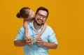 Happy father`s day! cute dad and daughter hugging on yellow back Royalty Free Stock Photo