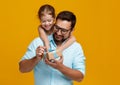 Happy father`s day! cute dad and daughter hugging on yellow back Royalty Free Stock Photo