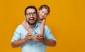 Happy father`s day! cute dad and daughter hugging on yellow back Royalty Free Stock Photo