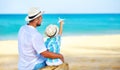 Happy father`s day! dad and child son on beach by sea with model toy plane