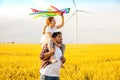 Father and daughter having fun, playing with kite together Royalty Free Stock Photo