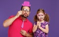 Happy father`s day! funny dad and daughter with mustache fooling Royalty Free Stock Photo