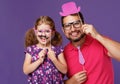 Happy father`s day! funny dad and daughter with mustache fooling Royalty Free Stock Photo