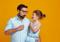 Happy father`s day! funny dad and daughter with mustache fooling Royalty Free Stock Photo