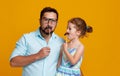 Happy father`s day! funny dad and daughter with mustache fooling Royalty Free Stock Photo