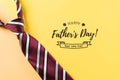 Happy Father`s Day inscription with plaid tie on pastel yellow background with text Royalty Free Stock Photo