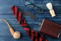 Happy father`s day. men`s tie, glasses and men`s accessories on a blue wooden table. men`s holiday. top view Royalty Free Stock Photo