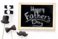 Happy Father`s day cards. Black tie, mustache and hat cookies and gift. White desk background top view Royalty Free Stock Photo