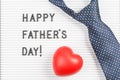 Happy father`s day text on letter board and tie with heart