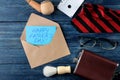 Happy father`s day. Text on paper and man`s tie, glasses and men`s accessories on a blue wooden table. men`s holiday. top view Royalty Free Stock Photo