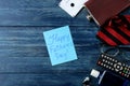 Happy father`s day. Text on paper and man`s tie, glasses and men`s accessories on a blue wooden table. men`s holiday. top view Royalty Free Stock Photo