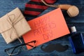 Happy father`s day. Text on paper and man`s tie, glasses and men`s accessories on a blue wooden table. men`s holiday. top view Royalty Free Stock Photo