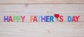 Happy Father`s Day text with red heart shape on wooden background. International Men`s Day concepts