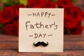 Happy Father`s Day text with Red roses in a bunch as a background. Royalty Free Stock Photo