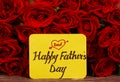 Happy Father`s day text with Red roses in a bunch as a background. Royalty Free Stock Photo