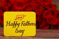 Happy Father`s Day text with Red roses in a bunch as a background. Royalty Free Stock Photo