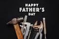 Happy father`s day text sign on working tools hammer wrench plie Royalty Free Stock Photo
