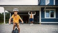 Happy Father Showing His Son to Ride a Bicycle on the Lawn in The Front Yard of Their Home. Young