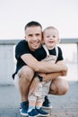 Happy father sitting and embracing his toddler boy Royalty Free Stock Photo