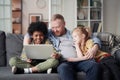 Father with children using laptop at home Royalty Free Stock Photo