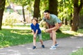 Happy father and son compete in running at park