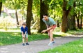 Happy father and son compete in running at park