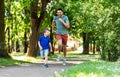 Happy father and son compete in running at park