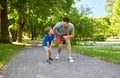 Happy father and son compete in running at park