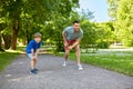 Happy father and son compete in running at park