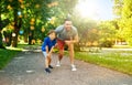 happy father and son compete in running at park