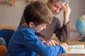 Happy father and son cooperating on mathematics homework Royalty Free Stock Photo