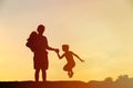 Happy father with son and daughter jumping at sunset Royalty Free Stock Photo