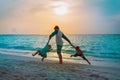 Happy father with son and daughter play on sunset beach Royalty Free Stock Photo