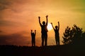 Happy father with son and daughter silhouettes play in sunset Royalty Free Stock Photo