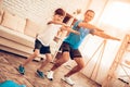 Happy Father and Son Doing Squats in Apartment.