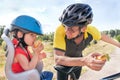 Happy father and son is eating lunch (snack) during bicycle ride Royalty Free Stock Photo